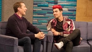 Joe Jonas Wears a Maroon and Gold Letterman Jacket With White Sneakers